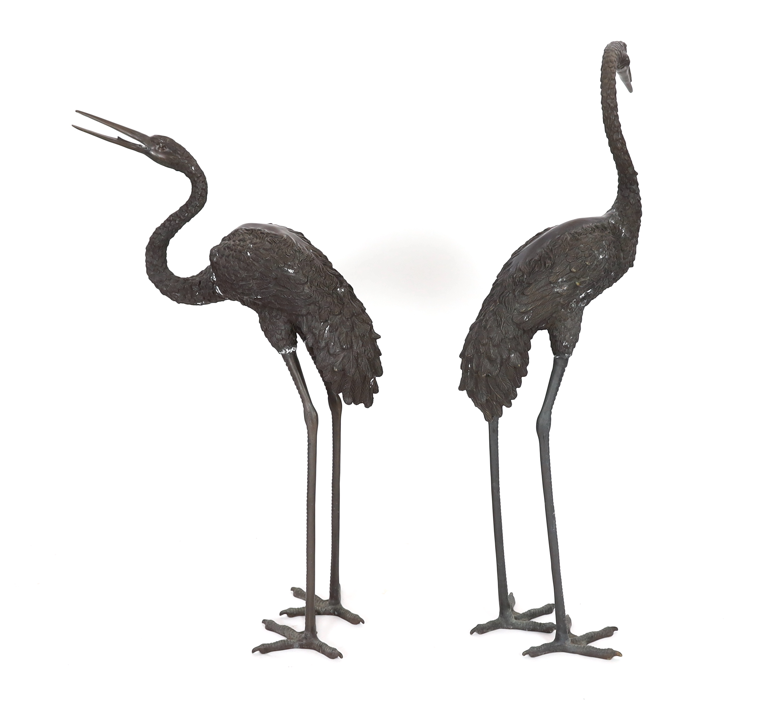 A pair of 20th century Chinese bronze garden models of cranes, 140cm and 157cm high